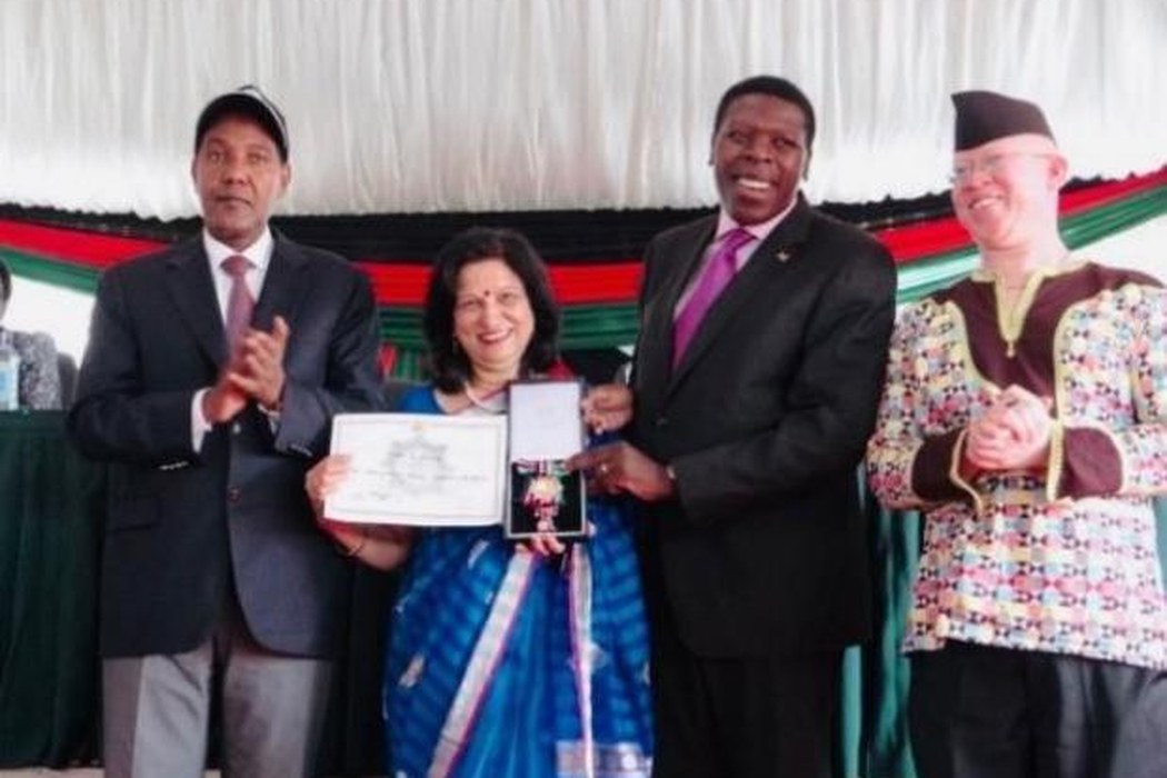 Dr. Choksey receiving the Moran of the Order of the Burning Spear