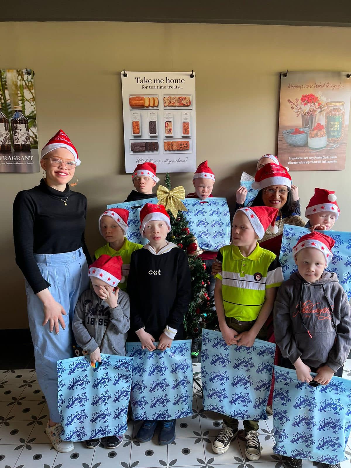 Children with albinism holding gift bags at a foundation event